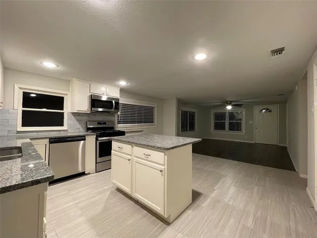 a kitchen with a sink stove and microwave