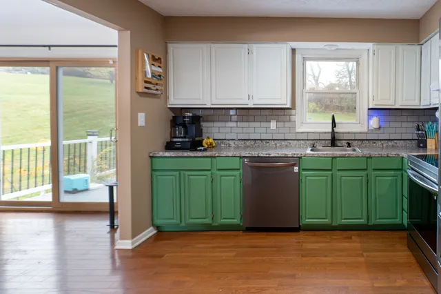 a kitchen with a sink a window and cabinets