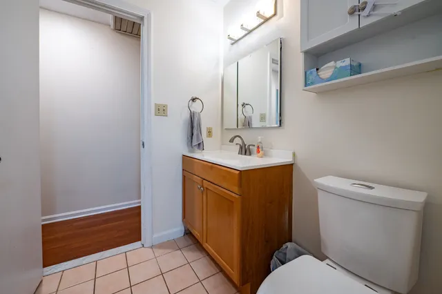 a bathroom with a sink toilet and mirror