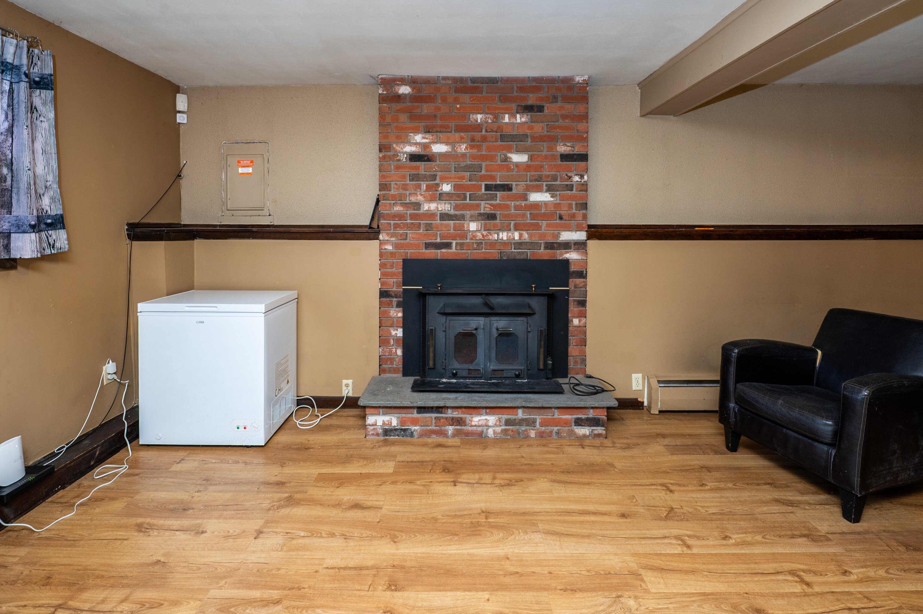 52 Cimarron Road Middletown, CT 06457 - Photo 22 of 31 a living room with furniture a flat screen tv and a fireplace