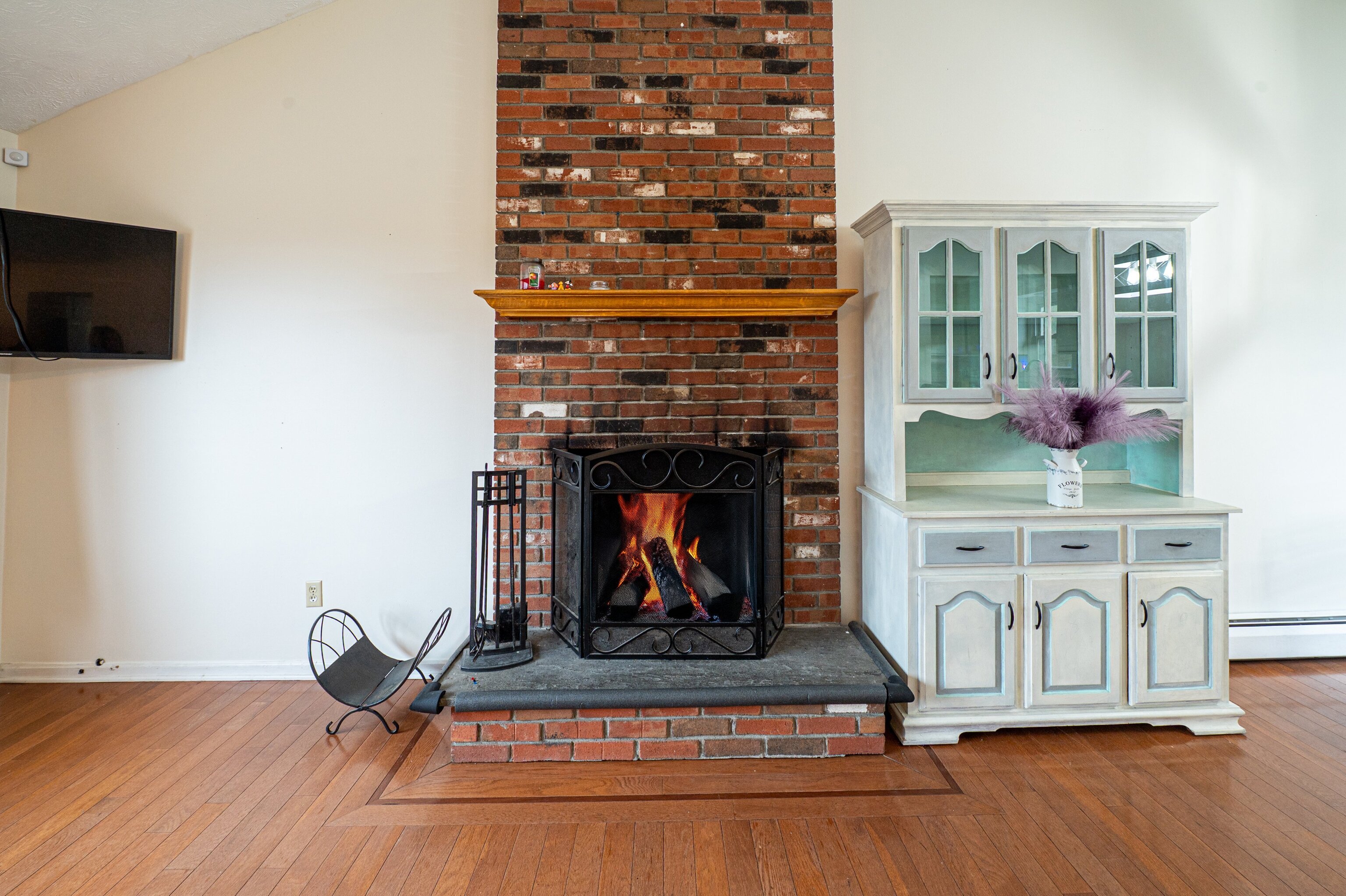 52 Cimarron Road Middletown, CT 06457 - Photo 6 of 31 a living room with furniture a fireplace and flat screen tv