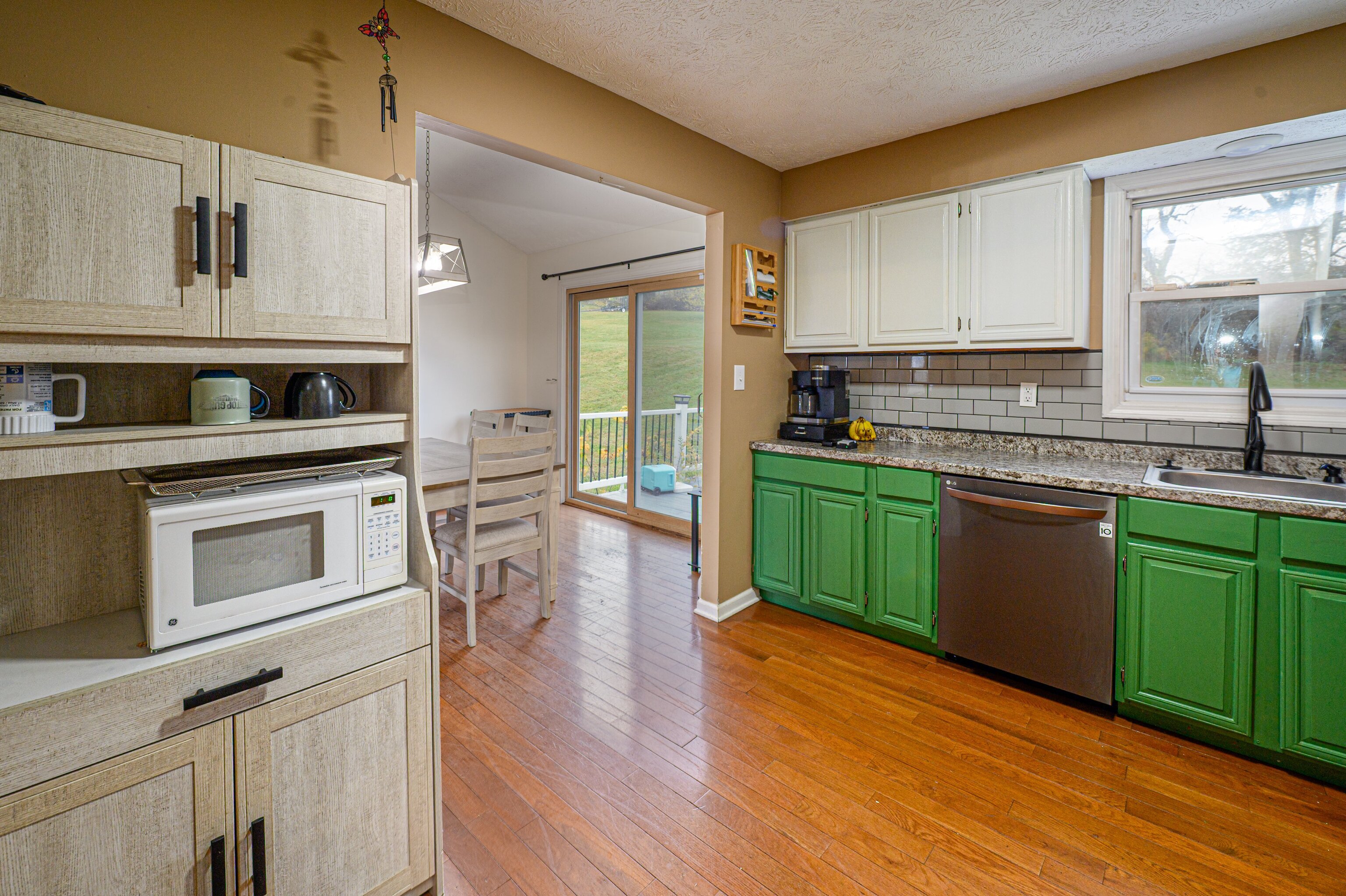 52 Cimarron Road Middletown, CT 06457 - Photo 9 of 31 a kitchen with cabinets a sink and wooden floor