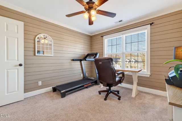 a living room with furniture a front door and a floor to ceiling window