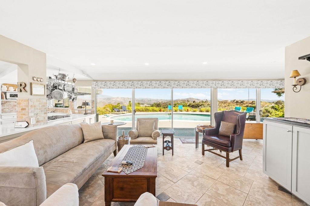 3730 Poppy Lane Fallbrook, CA 92028 - Photo 21 of 75 a living room with furniture and a floor to ceiling window