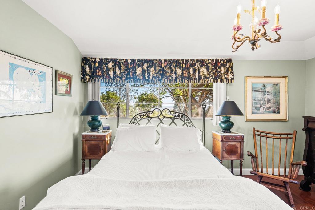 3730 Poppy Lane Fallbrook, CA 92028 - Photo 47 of 75 a bedroom with a large bed and a chandelier