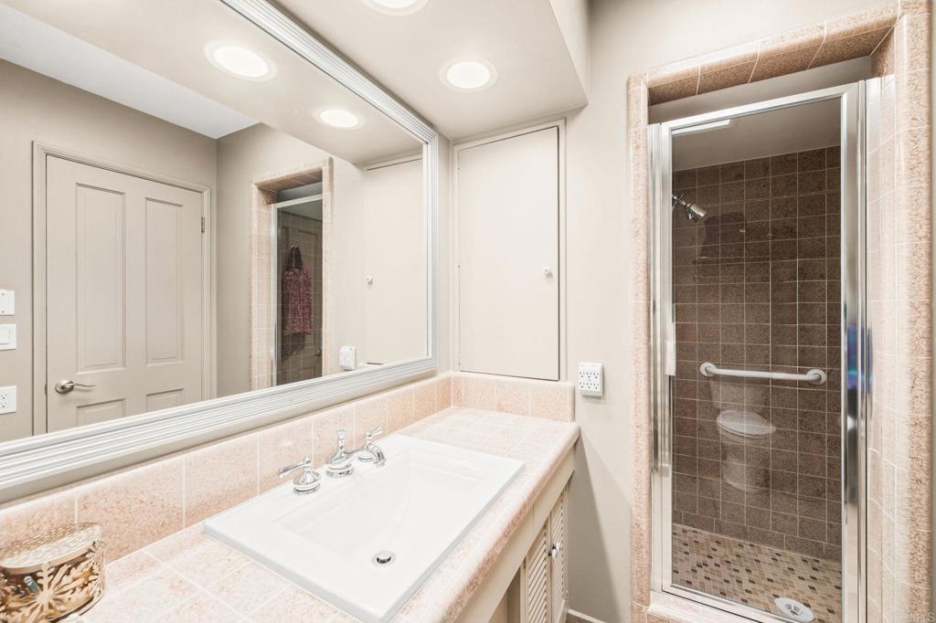3730 Poppy Lane Fallbrook, CA 92028 - Photo 49 of 75 a bathroom with a sink a mirror and a shower