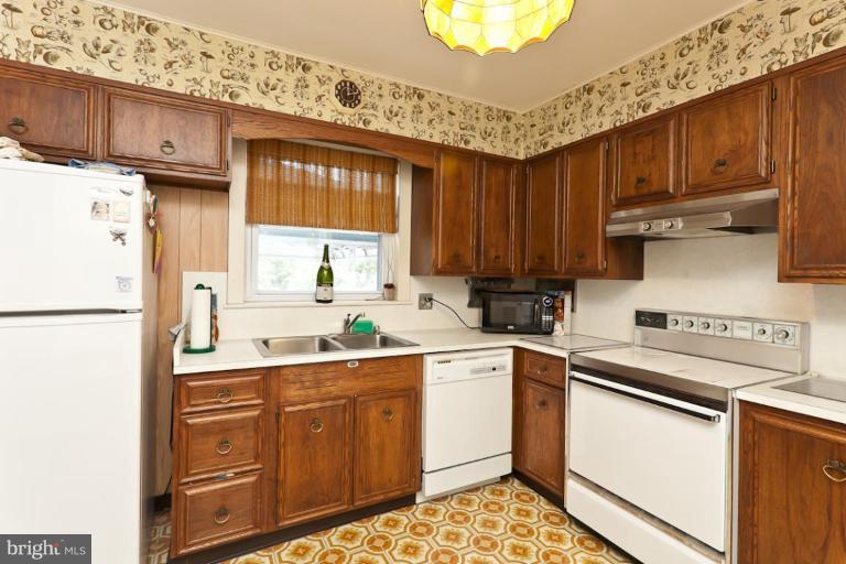 104 Cedarcroft Road Baltimore, MD 21212 - Photo 11 of 21 a kitchen with stainless steel appliances granite countertop a refrigerator sink and cabinets