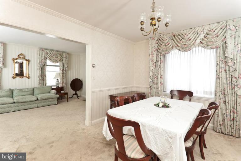 104 Cedarcroft Road Baltimore, MD 21212 - Photo 13 of 21 a view of a dining room with furniture and chandelier