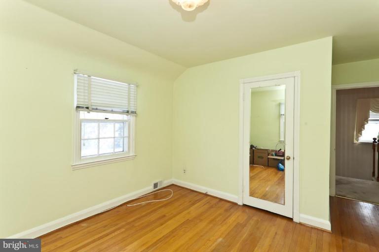 104 Cedarcroft Road Baltimore, MD 21212 - Photo 15 of 21 an empty room with wooden floor and a window