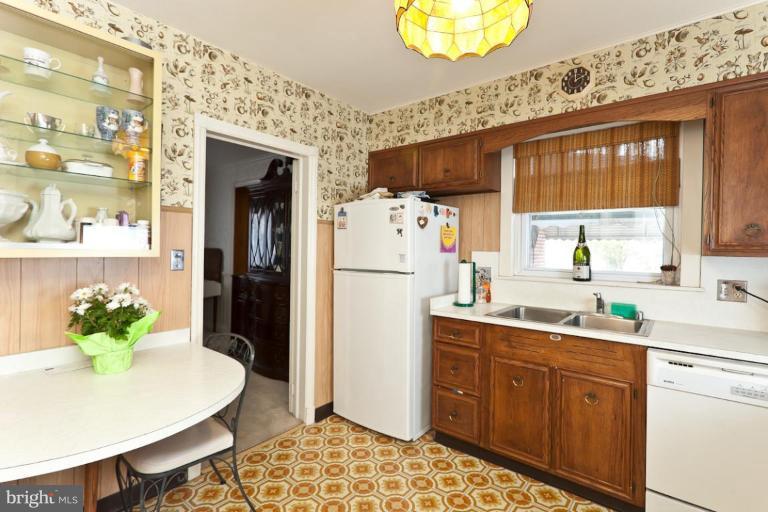 104 Cedarcroft Road Baltimore, MD 21212 - Photo 17 of 21 a kitchen with a refrigerator and a sink