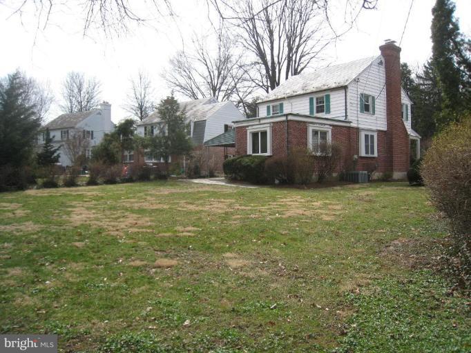 104 Cedarcroft Road Baltimore, MD 21212 - Photo 19 of 21 a view of a yard in front of a house with a large tree