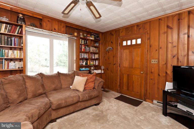 104 Cedarcroft Road Baltimore, MD 21212 - Photo 6 of 21 a living room with furniture a bookshelf and a window