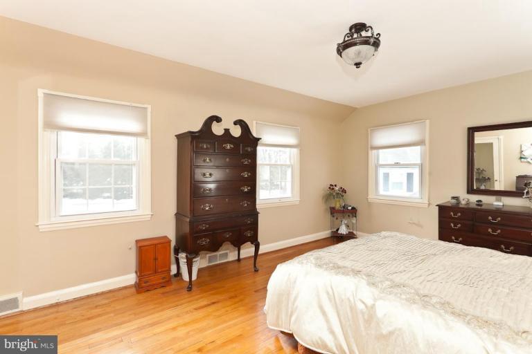 104 Cedarcroft Road Baltimore, MD 21212 - Photo 7 of 21 a bedroom with a bed and wooden floor