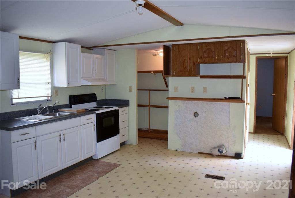 397 Tirzah Church Road, Unit 11 Lancaster, SC 29720 - Photo 8 of 18 a kitchen with stainless steel appliances a stove a sink and a refrigerator