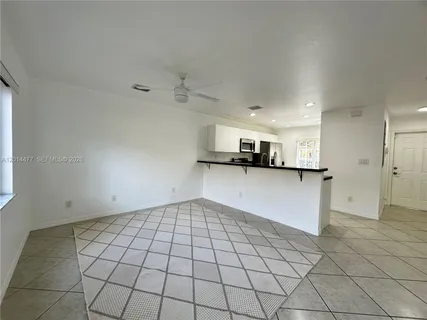 a view of kitchen with a sink and cabinets