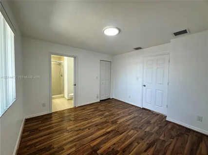 a view of room with wooden floor