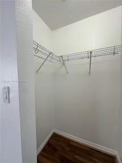 a bathroom with a granite countertop sink a mirror and a shower