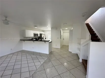 a kitchen with stainless steel appliances a refrigerator and a stove top oven