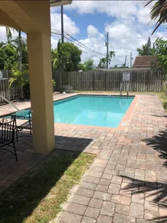 a view of a backyard with sitting area