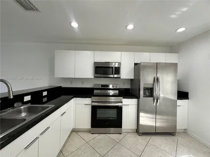 a kitchen with stainless steel appliances a stove sink and refrigerator