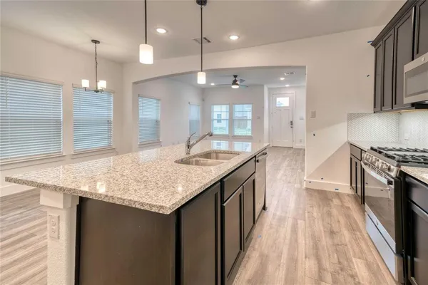 a kitchen with a stove and a sink