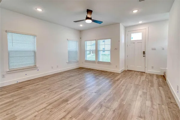 wooden floor in an empty room with a window