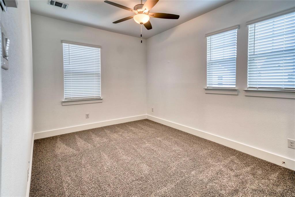 1403 Avocado Lane Gainesville, TX 76240 - Photo 6 of 8 an empty room with windows and fan