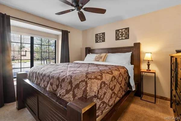 a bed sitting in a bedroom next to a window