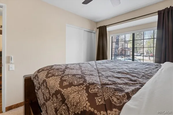 a bedroom with a bed and a large window