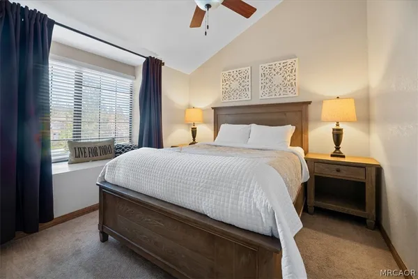 a bedroom with a bed and a large window