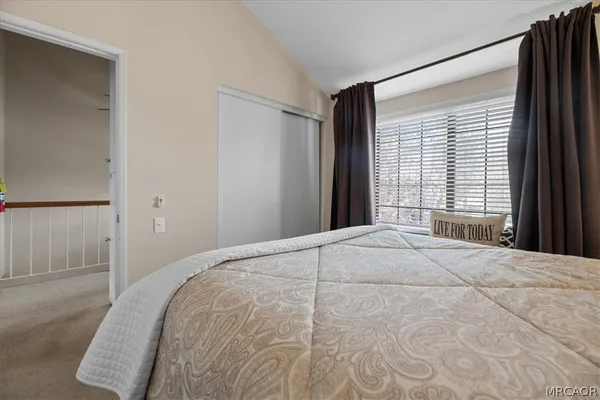 a bedroom with a large bed and a large window