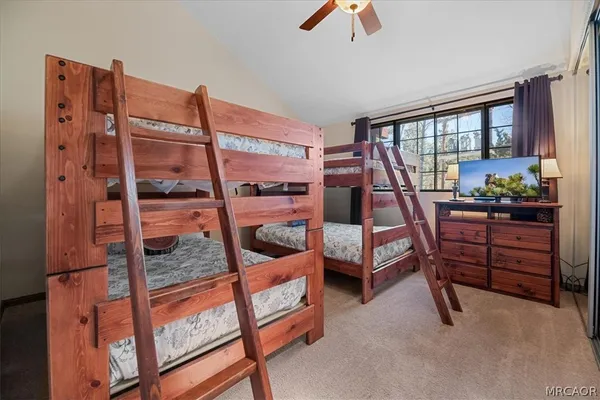 a bedroom with furniture and a large window