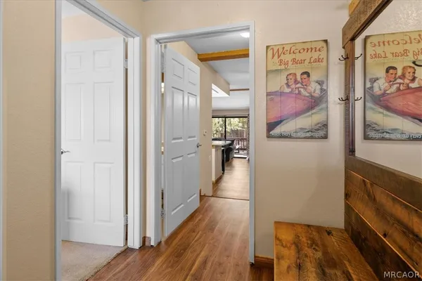 a view of a hallway with wooden floor and furniture