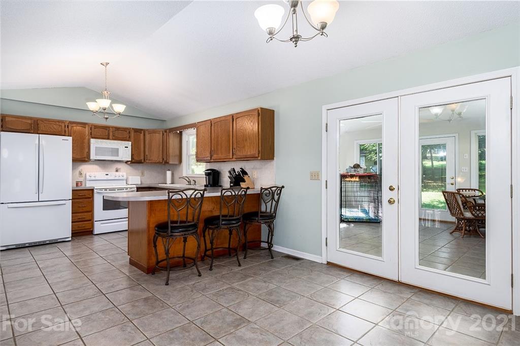 104 Rachel Street Morganton, NC 28655 - Photo 11 of 33 a kitchen with cabinets and chairs