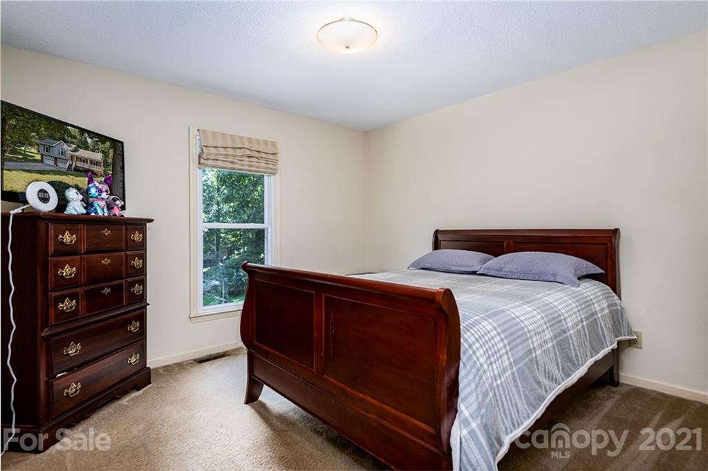 104 Rachel Street Morganton, NC 28655 - Photo 16 of 33 a bedroom with a bed and a dresser