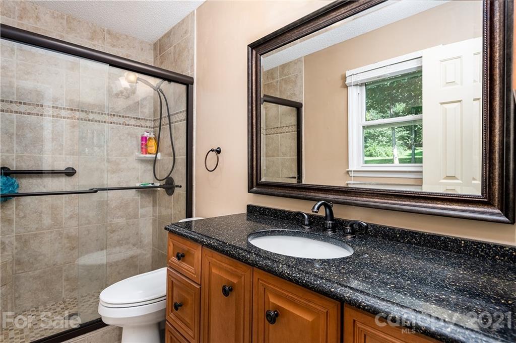 104 Rachel Street Morganton, NC 28655 - Photo 21 of 33 a bathroom with a granite countertop sink and a large mirror