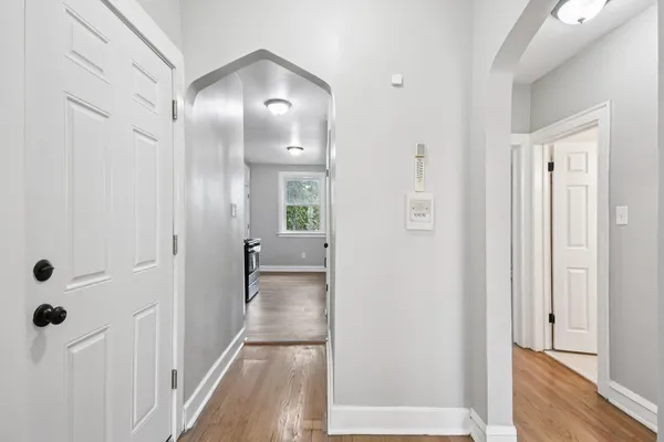 a view of a hallway with wooden floor