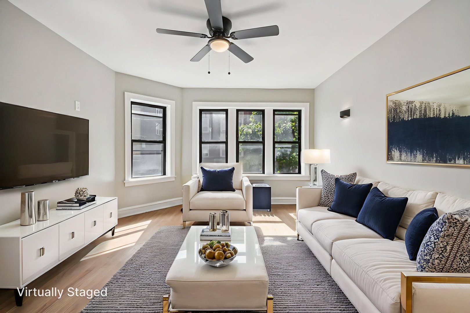 7757 South Phillips Avenue, Unit 3 Chicago, IL 60649 - Photo 13 of 14 a living room with furniture and a flat screen tv