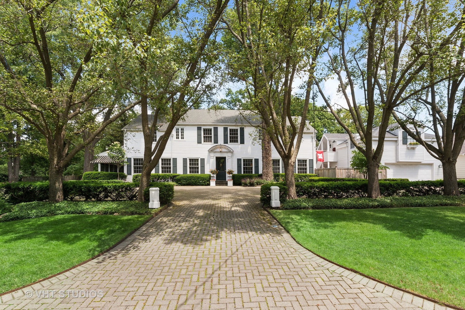 811 Sunset Road Winnetka, IL 60093 - Photo 2 of 40 a front view of a house with a yard