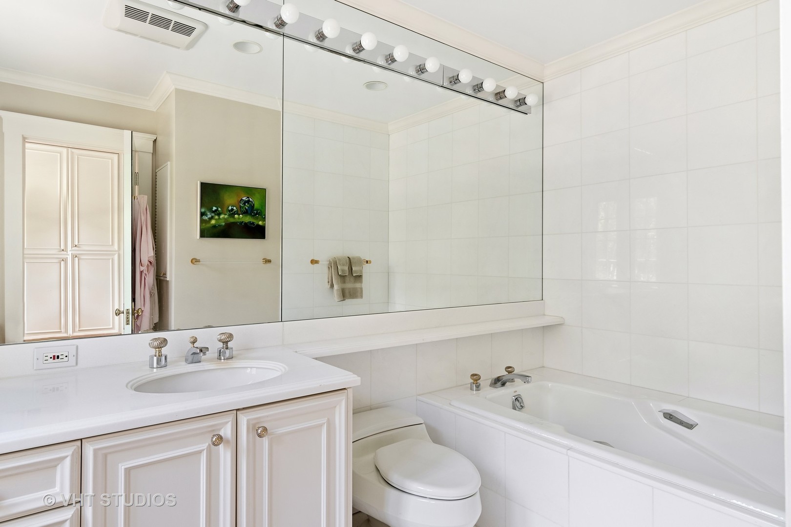 811 Sunset Road Winnetka, IL 60093 - Photo 20 of 40 a bathroom with a granite countertop sink a toilet a mirror and shower
