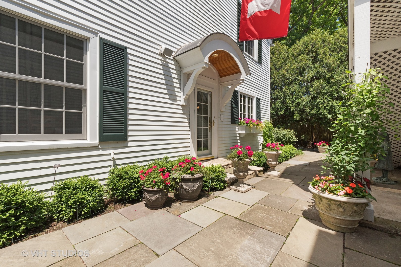 811 Sunset Road Winnetka, IL 60093 - Photo 33 of 40 a vase of flowers sitting in front of a house