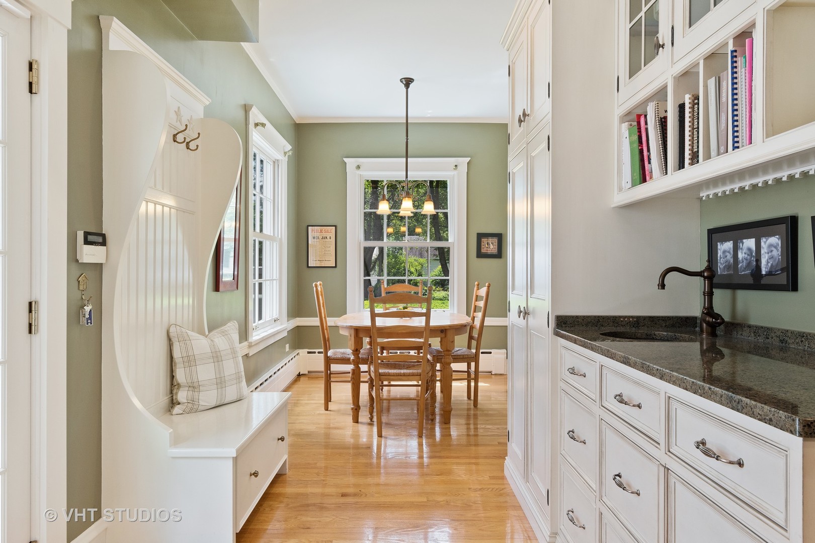 811 Sunset Road Winnetka, IL 60093 - Photo 6 of 40 a hallway with white cabinets and chandelier