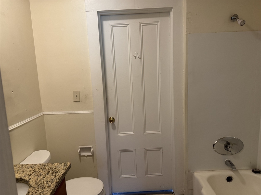 16 Tyler Park, Unit 9 Lowell, MA 01851 - Photo 8 of 10 a bathroom with a sink a toilet and shower