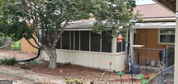 a view of a house with potted plants