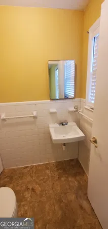 a bathroom with a sink mirror vanity and toilet