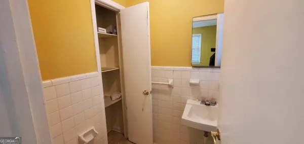 a kitchen with a sink and wooden floor
