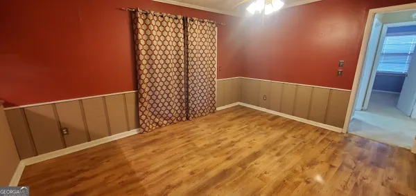 a view of a room with wooden floor and staircase
