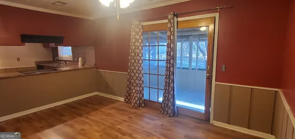 a kitchen with granite countertop a sink cabinets stainless steel appliances and a window