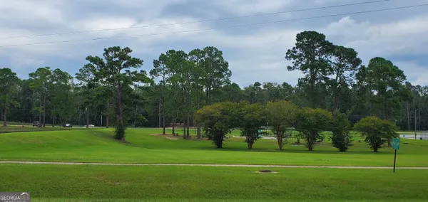 a view of a golf course with a big yard