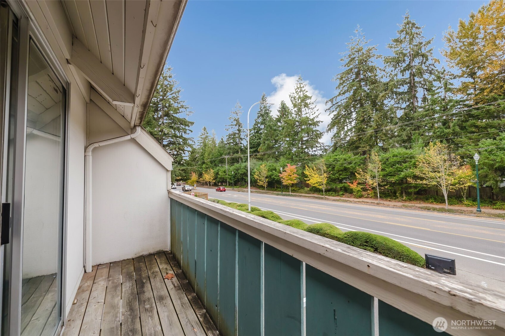 4311 67th Avenue West, Unit B Tacoma, WA 98466 - Photo 11 of 39 a view of a balcony with wooden floor and fence and a bench